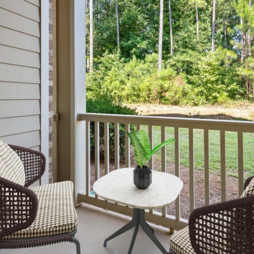 Find your perfect fit at The Willows at Ashley Park a table and chairs on a porch